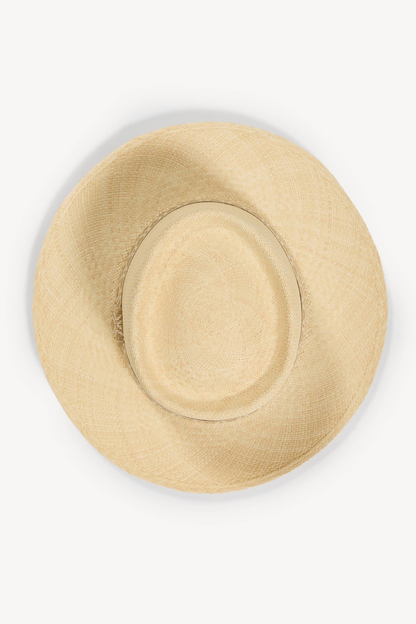 Beige handwoven Panama hat with a tan and white jacquard band on a white background