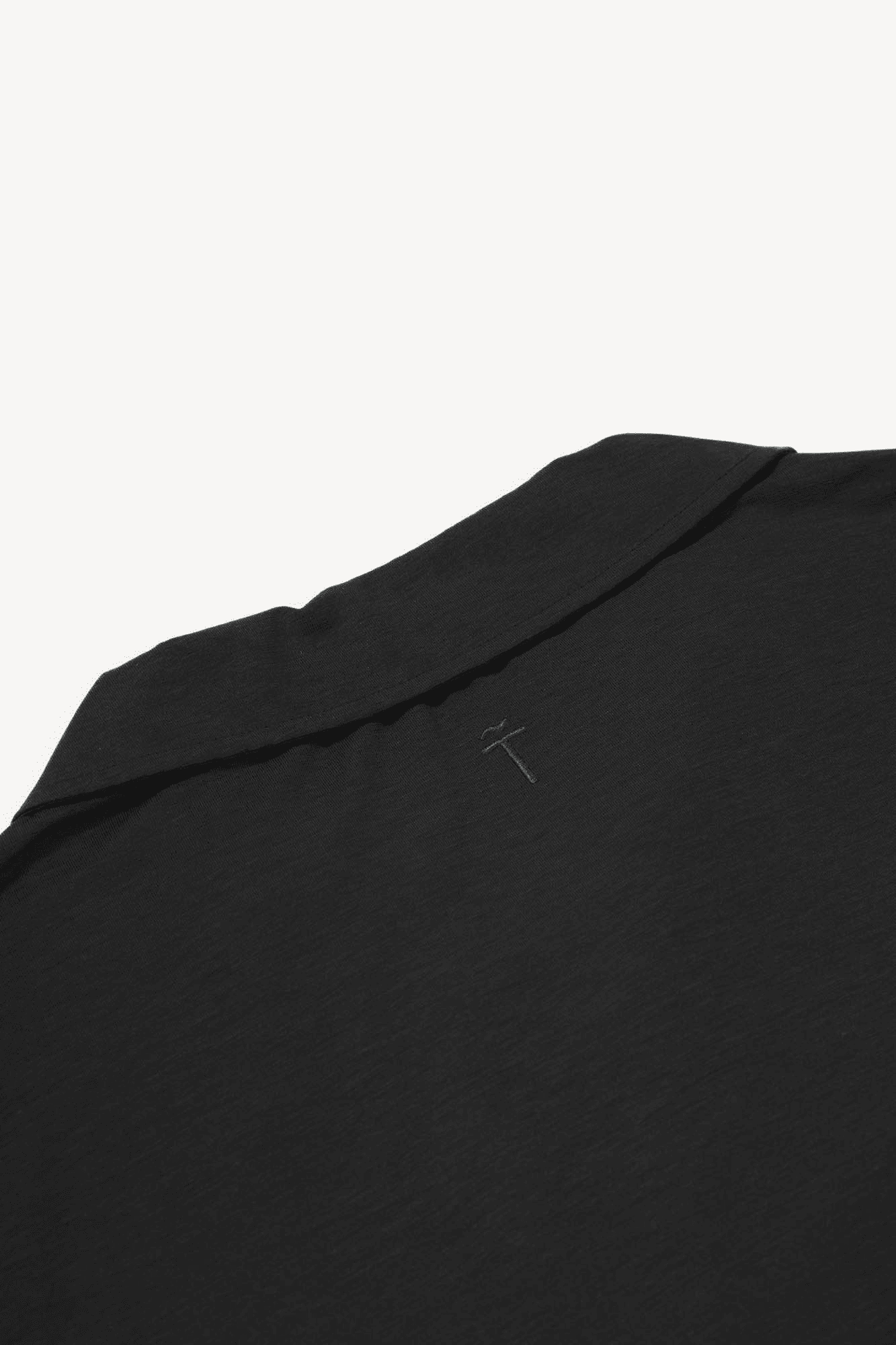 Black garment with a small logo on a white background
