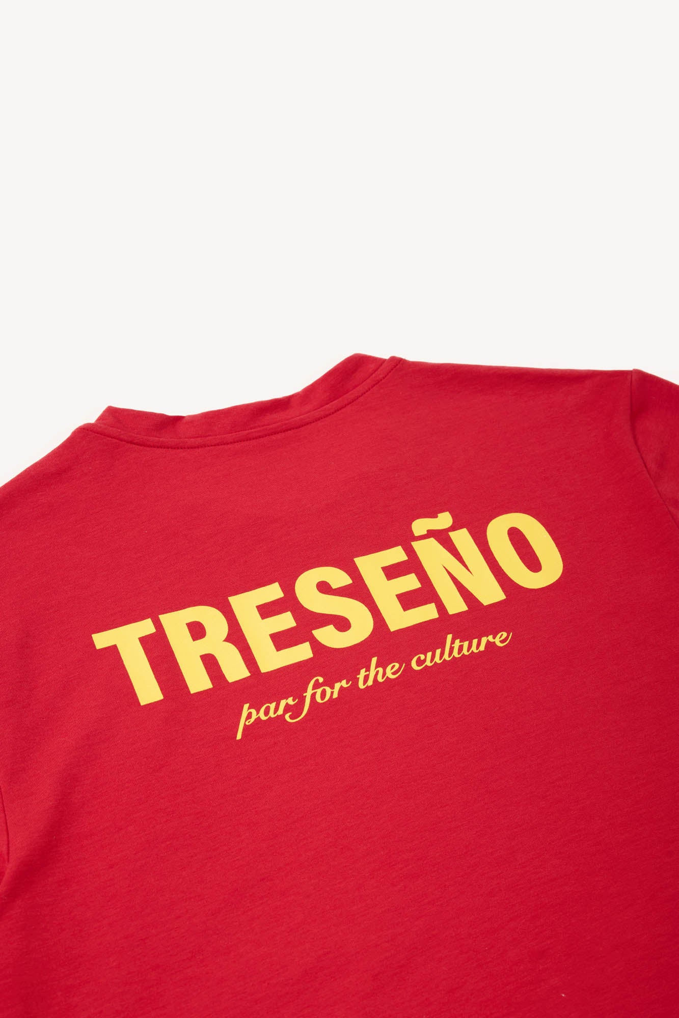 Red t-shirt with yellow text on a white background