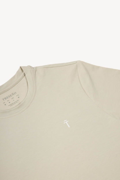 Beige t-shirt with a small logo on a white background