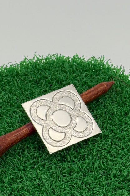 silver golf ball mark with Barcelona panot engraving