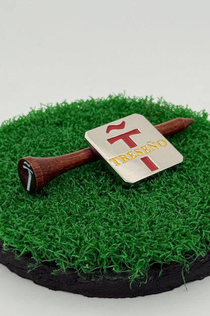 silver golf ball mark with Treseño engraving in red and yellow