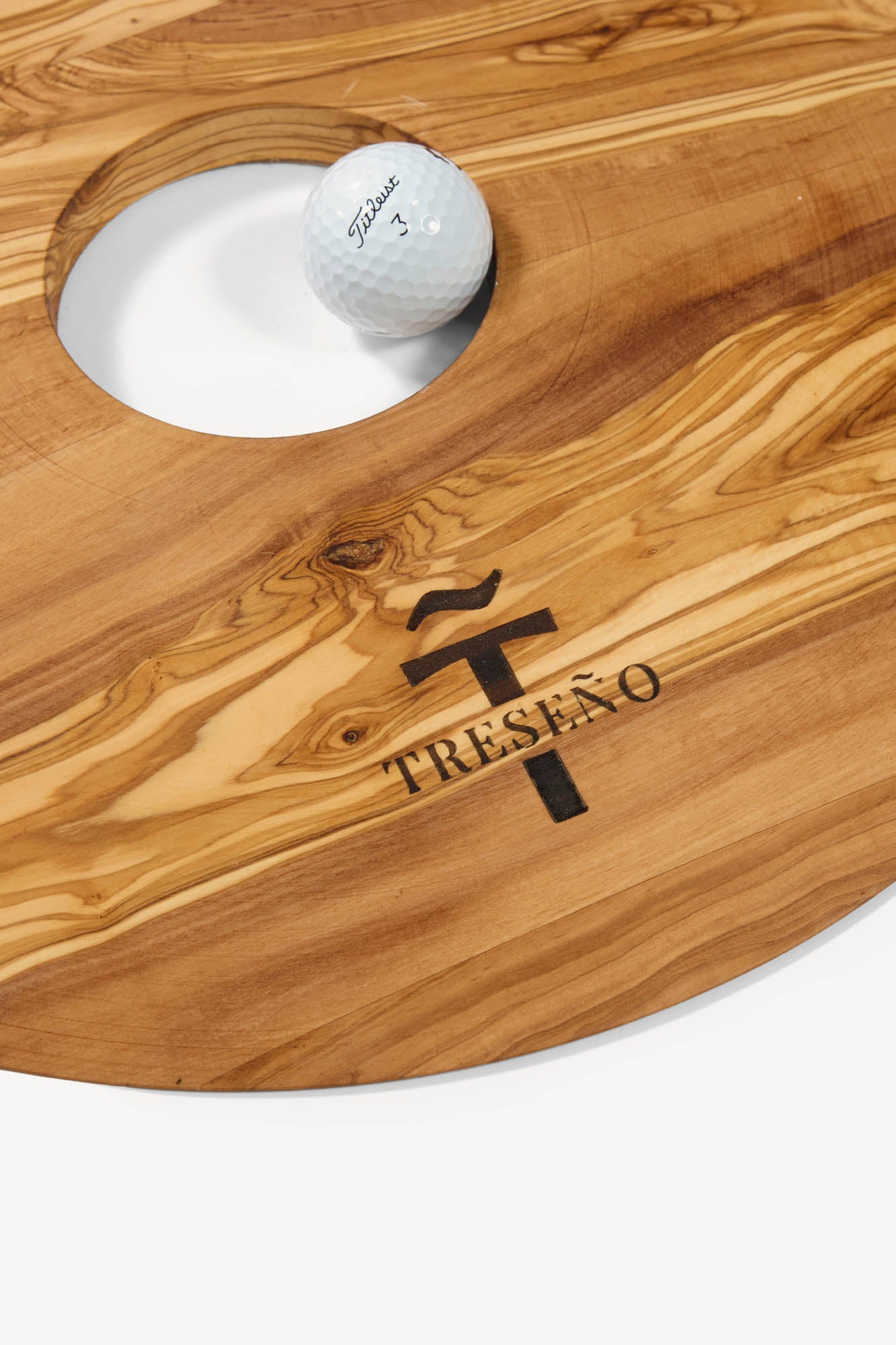 Luxury handcrafted Olive wood putting aid with a golf ball on a white background