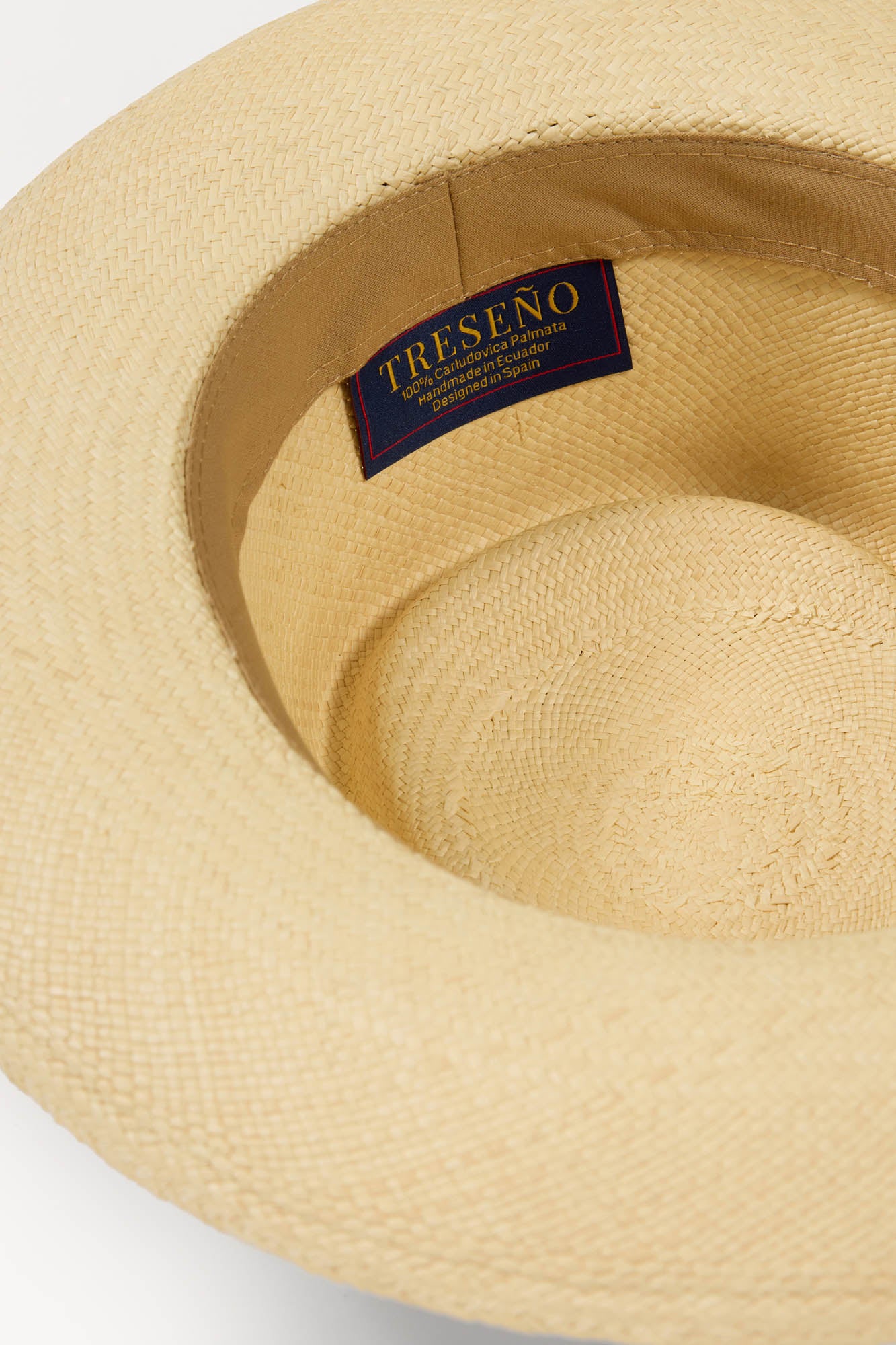 Beige Panama straw hat with a visible brand label on a light gray background