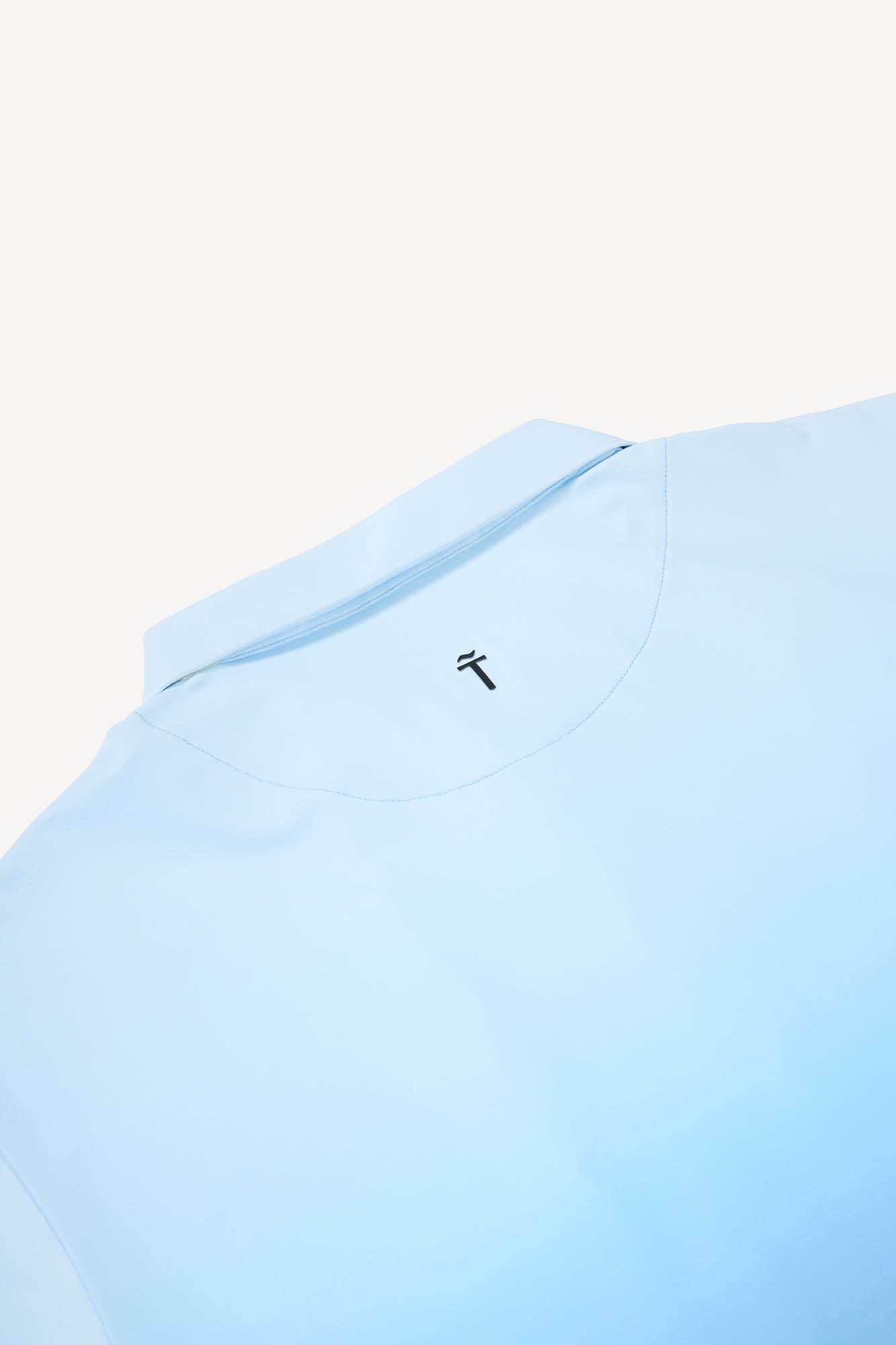 Light blue polo shirt with a small black Treseño logo on a white background