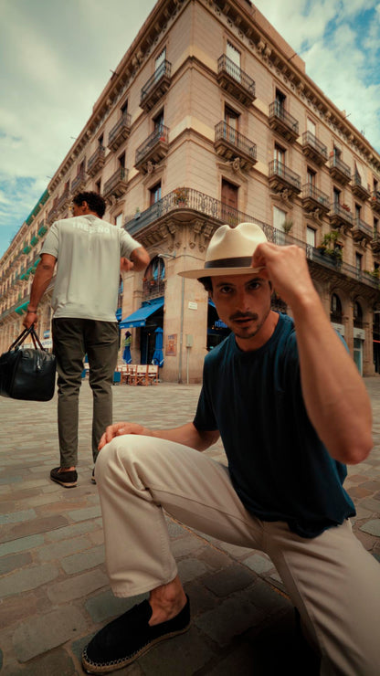 Two men in an urban setting with a building in the background