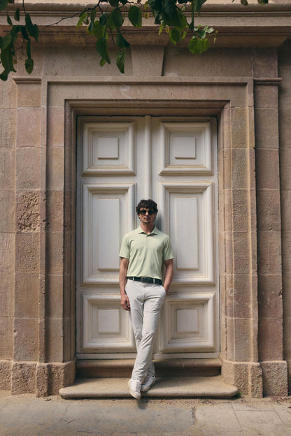Man standing in front of a large stone door with architectural details