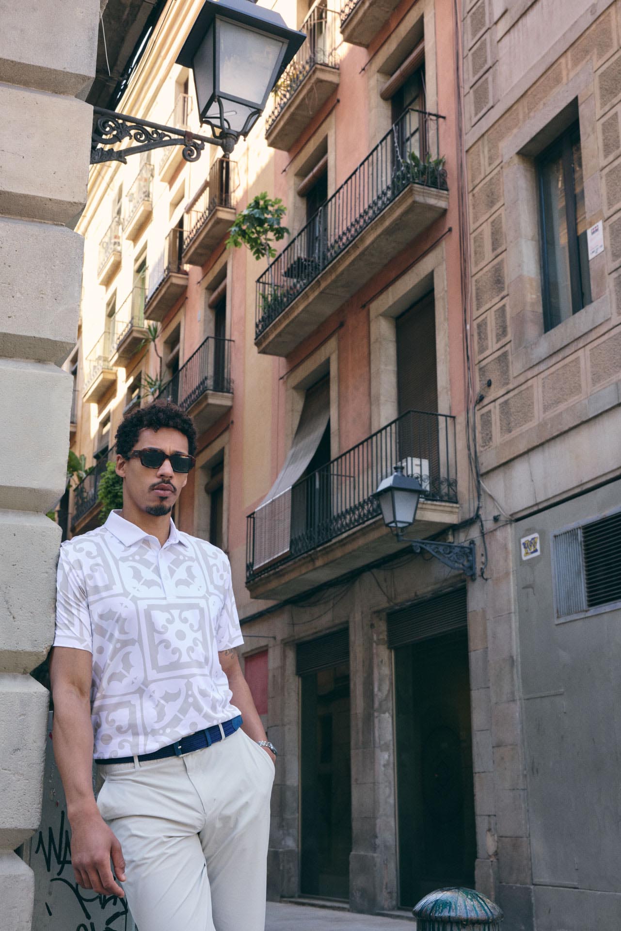 Man standing on a street with old buildings in the background