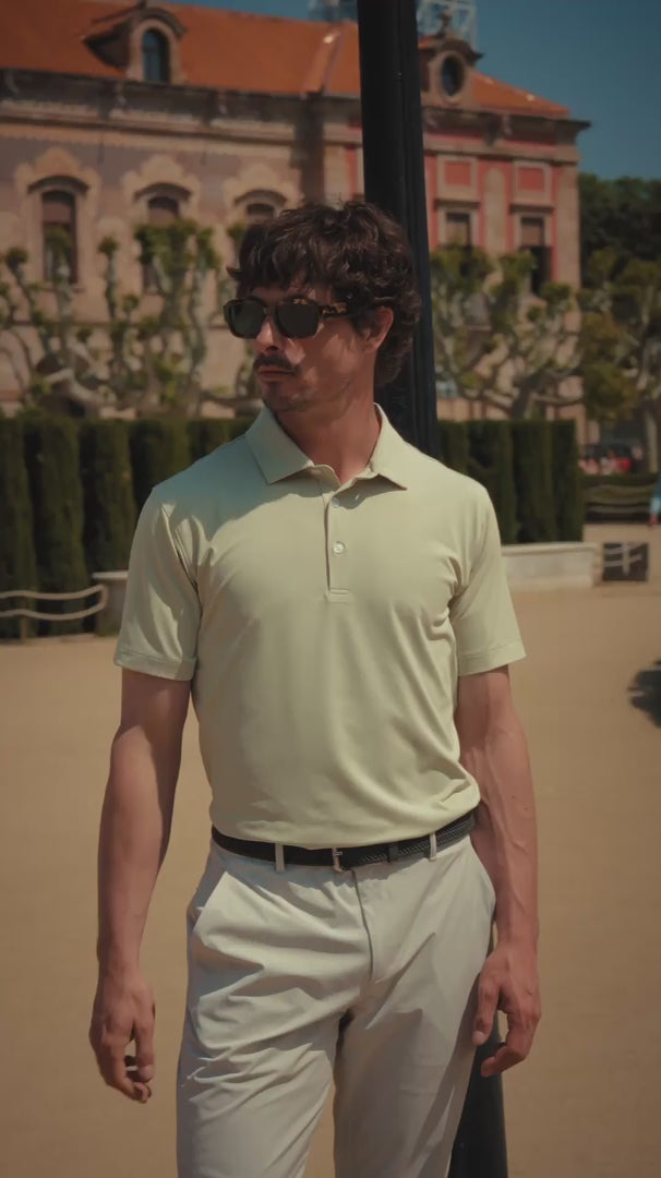 Man in light green polo in a scenic European courtyard