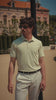 Man in light green polo in a scenic European courtyard